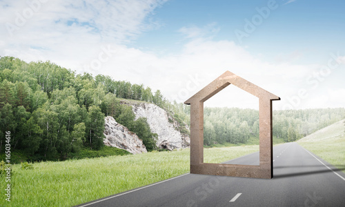 Conceptual background image of concrete home sign on asphalt road