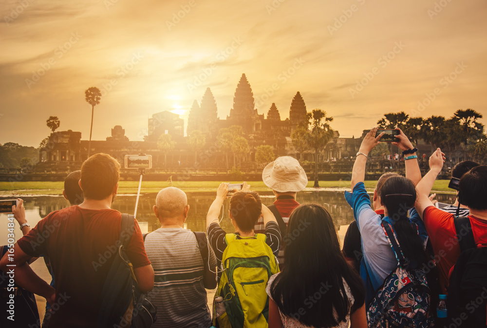 Naklejka premium Tourist waiting for see the sunrise over Angkor Wat the largest religious temple in the world, One of the most famous UNESCO world heritage sites of Siem Reap in Cambodia.