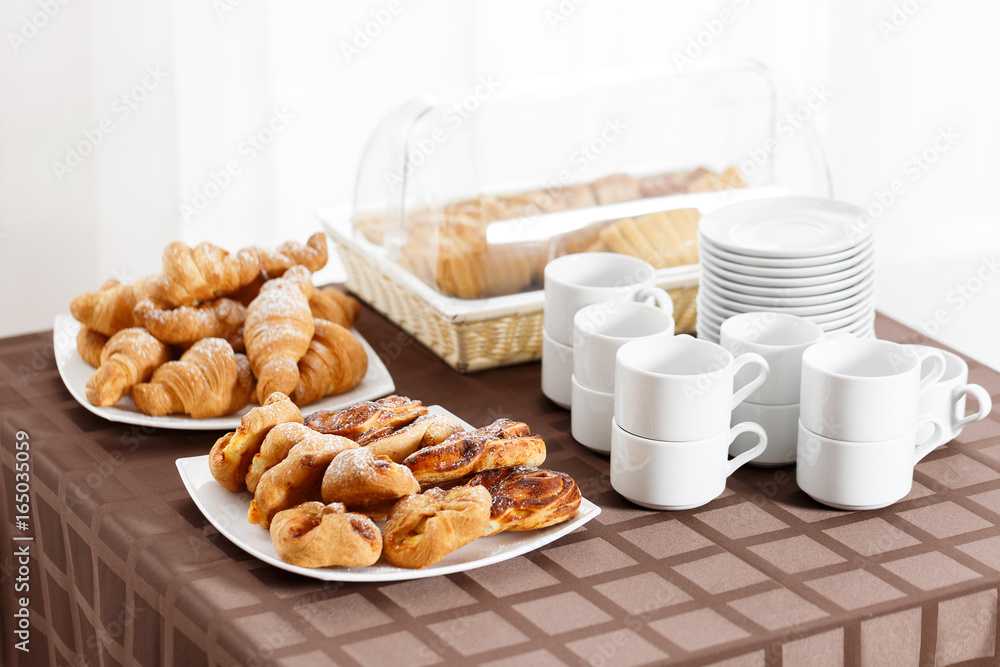 Breakfast at the hotel. croissants and puff in the foreground. selective focus Breakfast at the hotel. croissants and puff in the foreground. selective focus