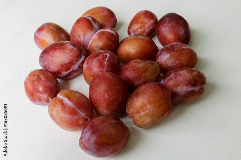 Vegan food. Fresh plum isolated on white background Vegan food. Fresh plum isolated on white background