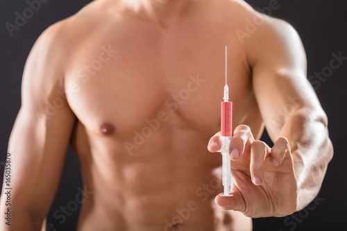 Shirtless Bodybuilder Man Holding Syringe In Hand
