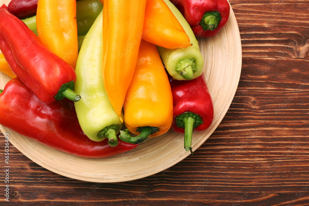 Fresh colored sweet peppers on the plate Fresh colored sweet peppers on the plate