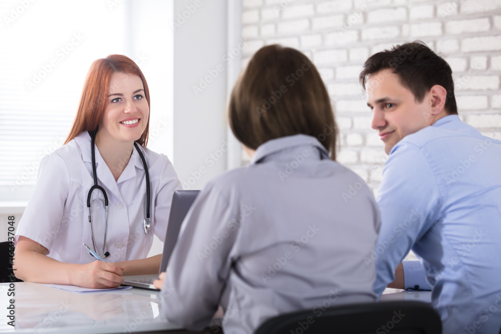 Couple Sitting In Front Of Female Doctor Couple Sitting In Front Of Female Doctor