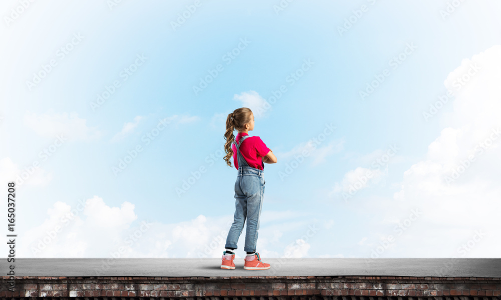 Concept of careless happy childhood with girl looking far away Concept of careless happy childhood with girl looking far away