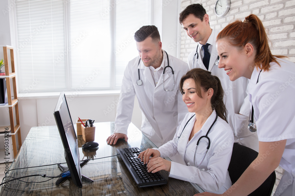 Fototapeta premium Group Of Doctors Looking At Computer