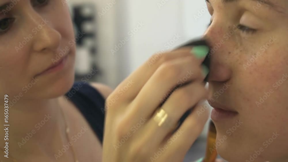 Professional make-up artist making face makeup art. Make up and fashion concept Professional make-up artist making face makeup art. Make up and fashion concept