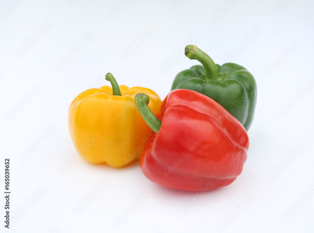 Green, red and yellow bell pepper isolated on white background. Green, red and yellow bell pepper isolated on white background.