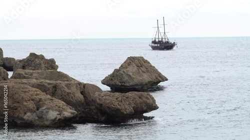 Rocky coast of mediterranean sea and boat photo