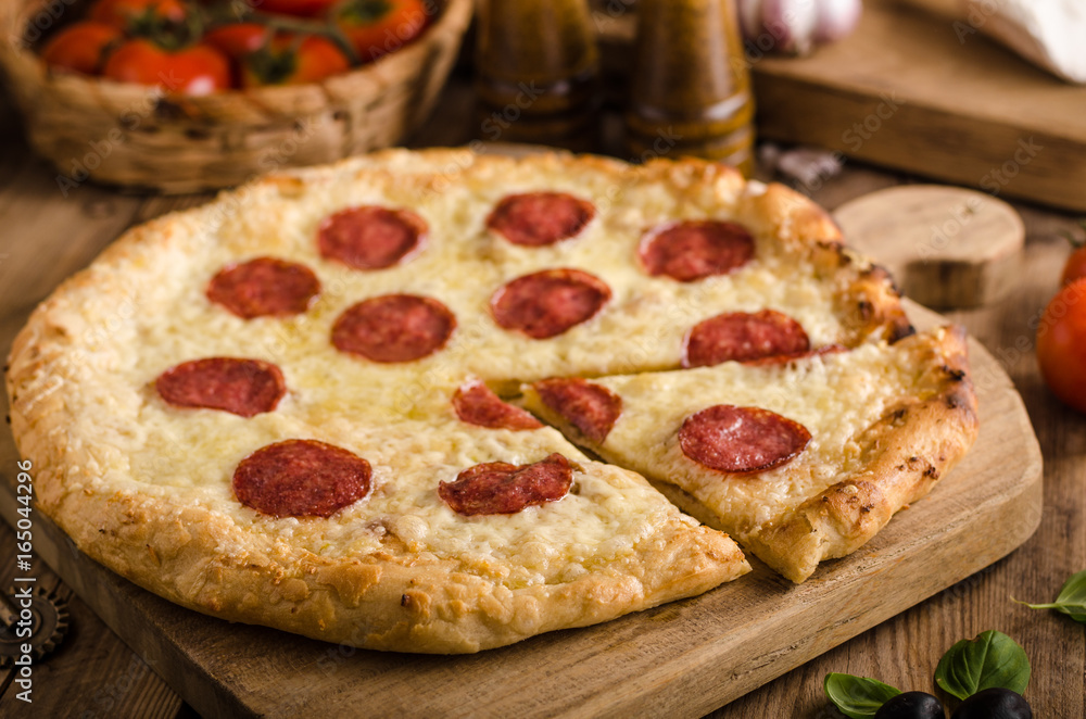 Rustic pizza with tomato, cheese, salami