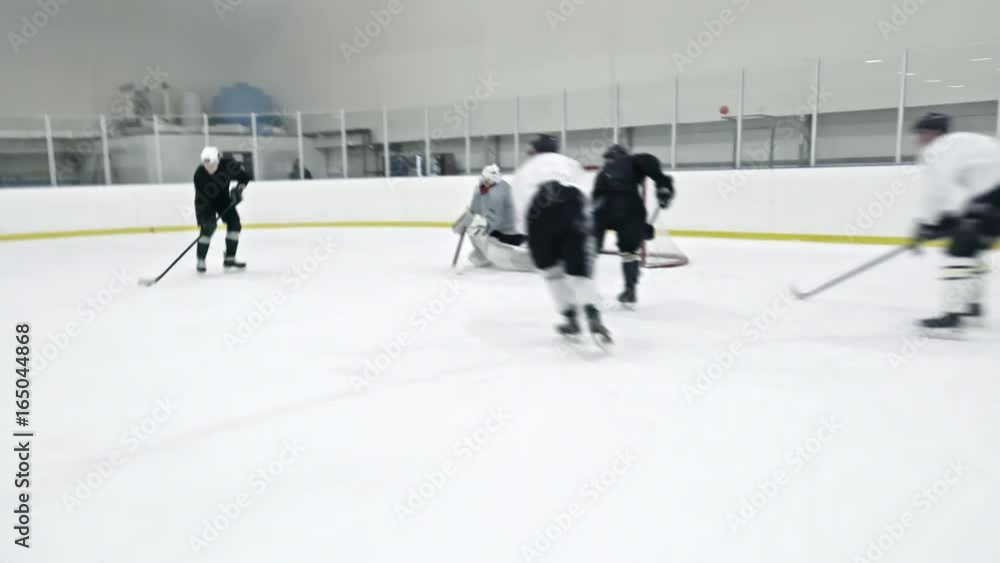 Tracking of ice hockey forward in black boarding opposite team player