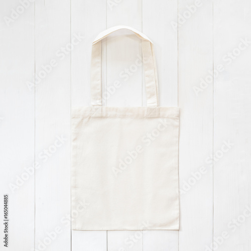 White tote bag mock up, fabric canvas cloth shopping sack template on wood table background