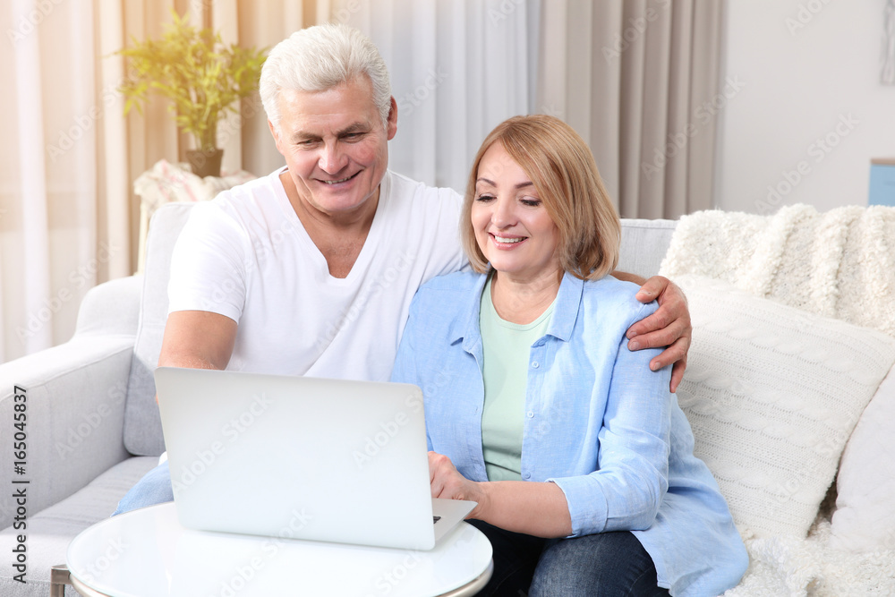 Grandparents using laptop at home Grandparents using laptop at home