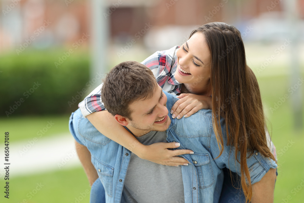 Fototapeta premium Happy couple of teens joking outdoors