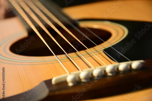Profesional view on guitar strings. Lower part of guitar.