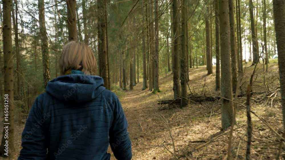 Tourist woman with backpack enjoying view to rainforest - flying camera shot