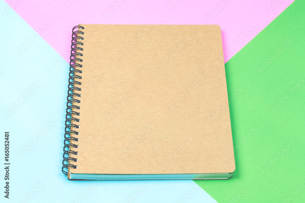 Brown notebook isolated on colorful background Brown notebook isolated on colorful background