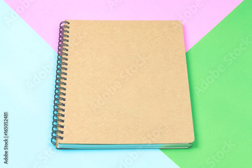 Brown notebook isolated on colorful background