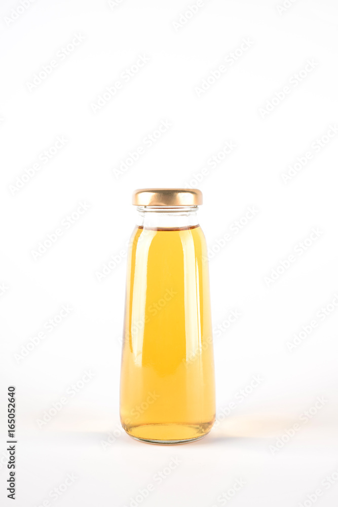 Small glass bottle of apple juice. Fruit drink in a bottle isolated on white background Small glass bottle of apple juice. Fruit drink in a bottle isolated on white background