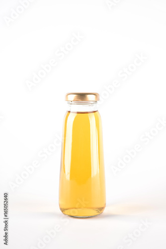 Small glass bottle of apple juice. Fruit drink in a bottle isolated on white background