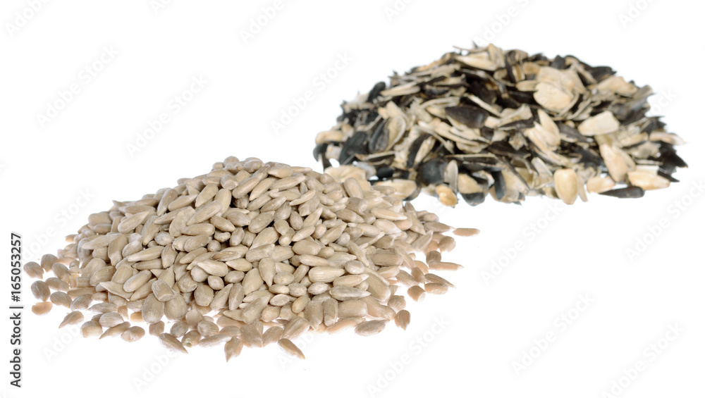 Sunflower seeds - pile of the kernels and pile of the husks isolated on white. Sunflower seeds - pile of the kernels and pile of the husks isolated on white.