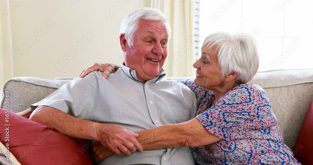 Senior couple interacting with each other in living room Senior couple interacting with each other in living room