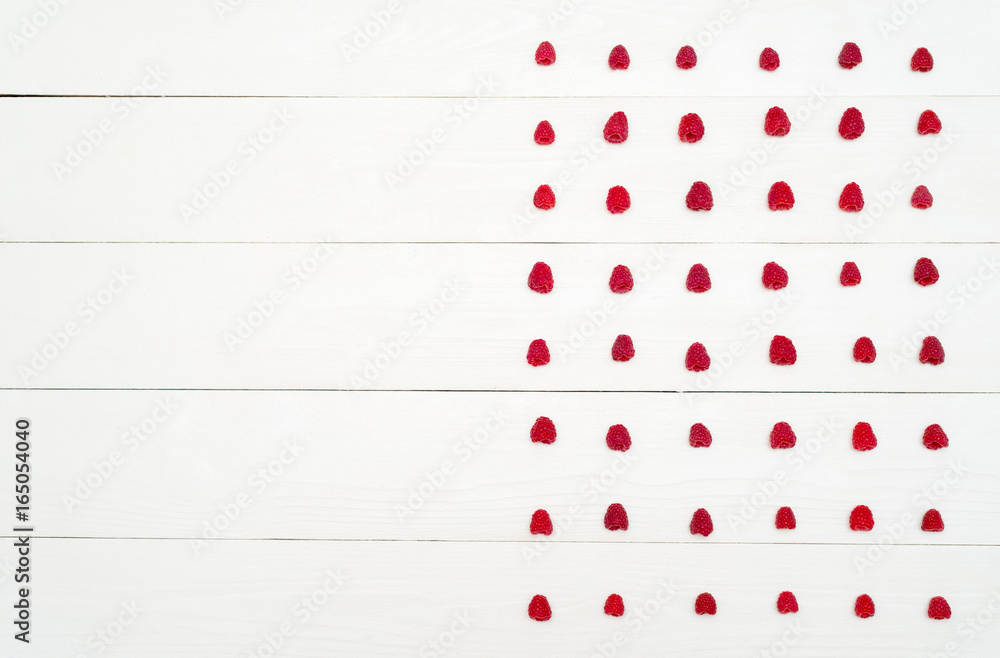 Top view of lines from sweet fresh organic raspberries, free space. Fresh berries on white wooden background with blank space. Summer and healthy food concept flat lay Top view of lines from sweet fresh organic raspberries, free space. Fresh berries on white wooden background with blank space. Summer and healthy food concept flat lay