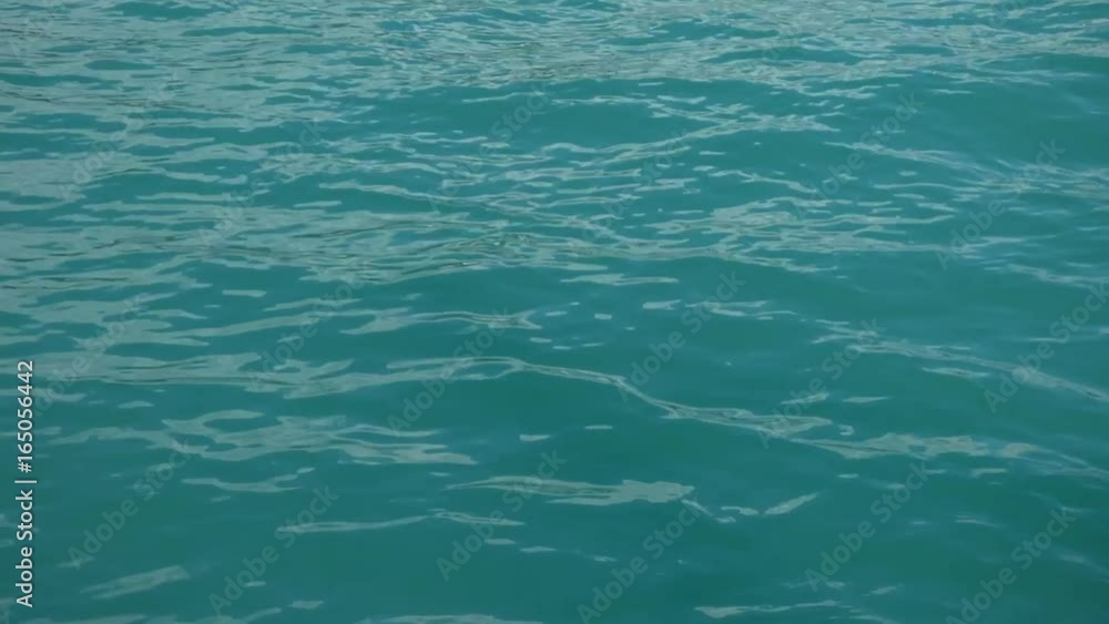 Sea or ocean surface with small waves. Abstract background - ripple on water motion sunny day. Sea or ocean surface with small waves. Abstract background - ripple on water motion sunny day.