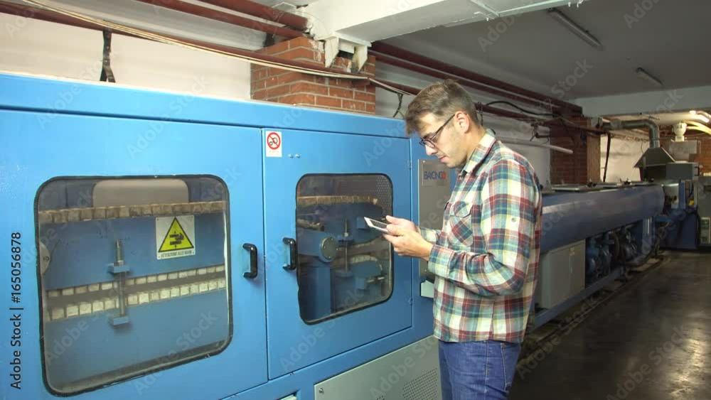 Engineer programs a machine for the production of propylene pipes 4k. Engineer programs a machine for the production of propylene pipes 4k.