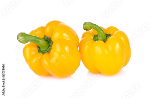 whole fresh yellow bell pepper with stem on white background