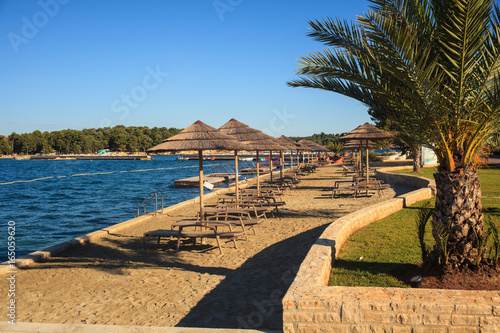 Fototapeta Naklejka Na Ścianę i Meble -  Beach umbrellas in Saint Nicholas island, Porec