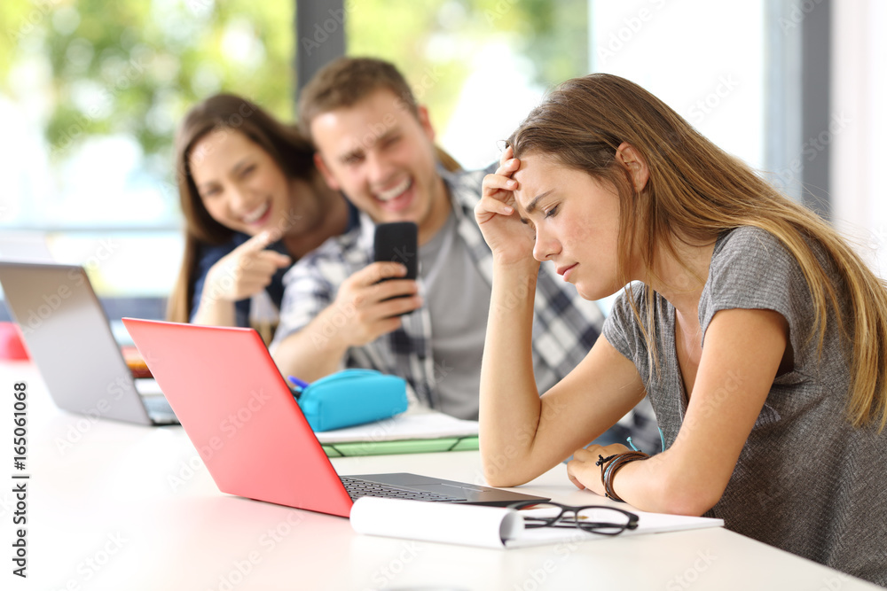 Sad student victim of cyber bullying Sad student victim of cyber bullying