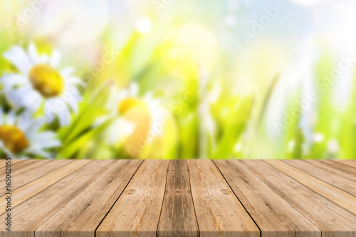 Wooden table with flower background 