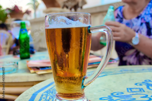Glass of beer on table with blurry background