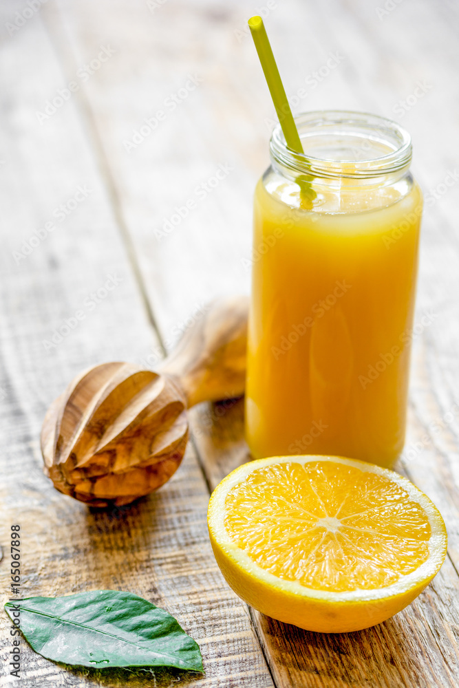 freshly squeezed orange juice in glass bottle on wooden backgrou freshly squeezed orange juice in glass bottle on wooden backgrou