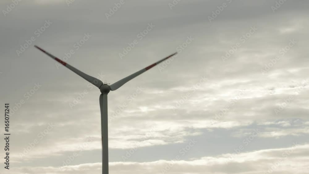 Wind turbine over stormy cloudy sky using renewable energy to generate electrical power. Renewable energy is most environmental way of power generation. Wind turbine over stormy cloudy sky using renewable energy to generate electrical power. Renewable energy is most environmental way of power generation.