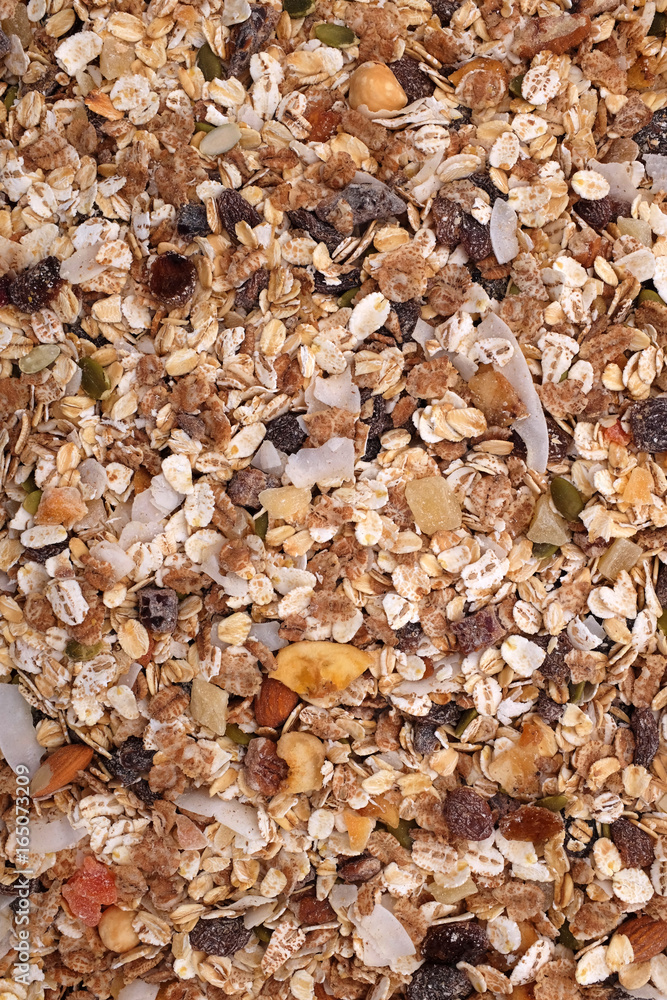 Muesli cereal with seeds, mixed fruit and nuts background Muesli cereal with seeds, mixed fruit and nuts background