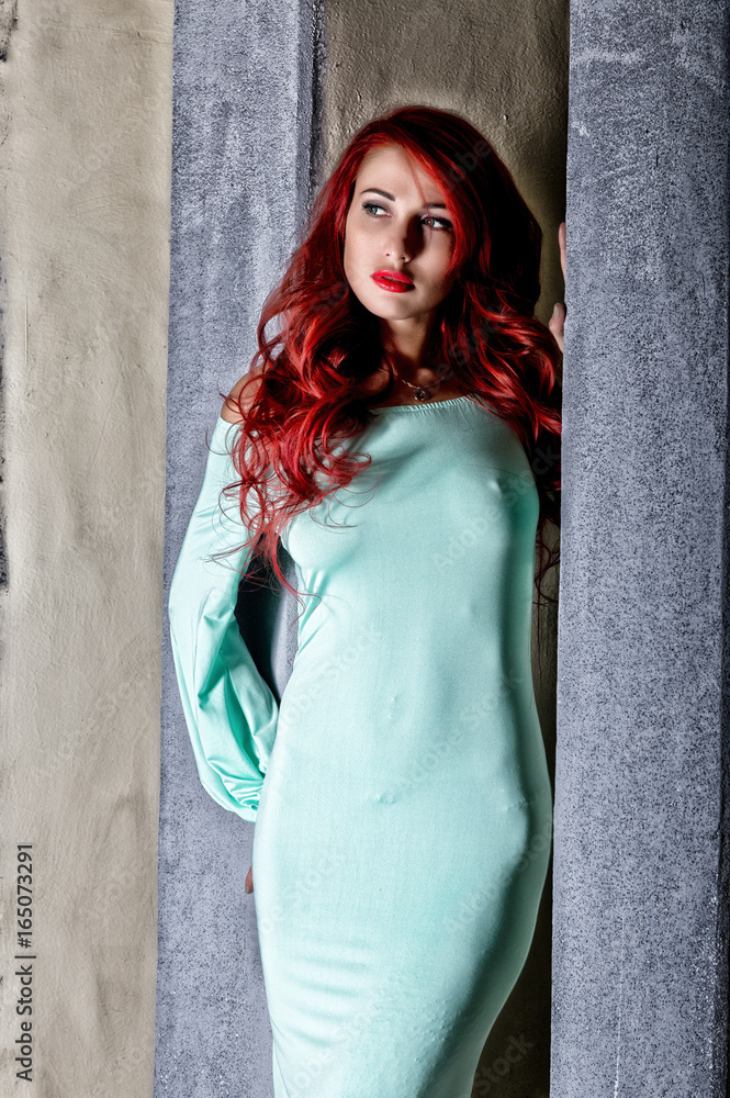 sexy beautiful redhead young woman with big boobs in a turquoise dress