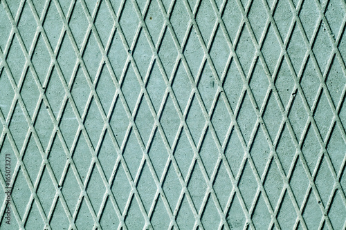 Cyan cement floor with diamond pattern.