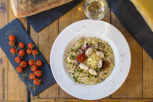 A plate of risotto with parmesan and chicken