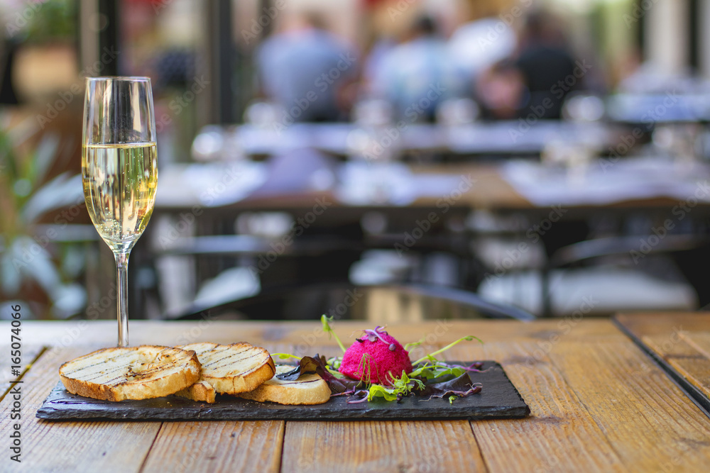 Red caviar with some toast and salad and a glass of champagne