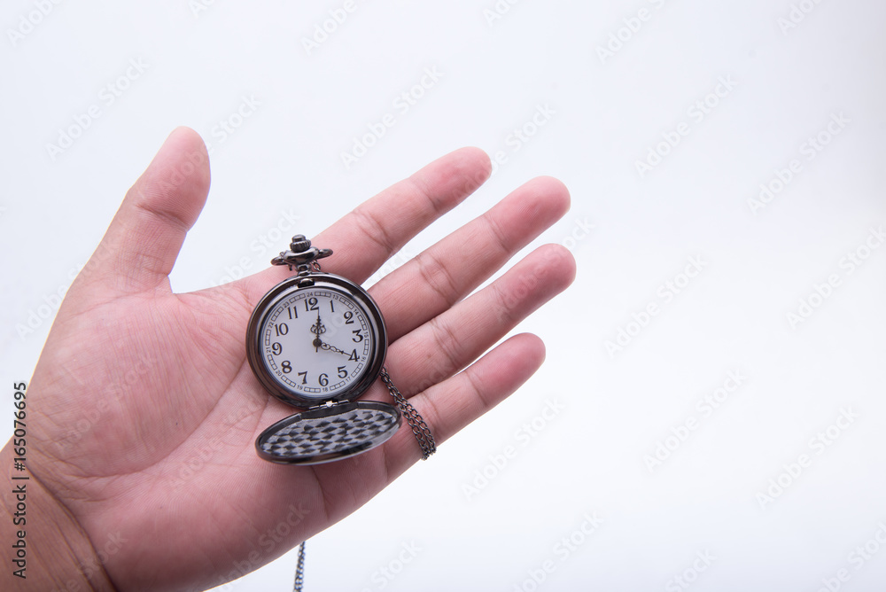 Hand holding an ancient clock watch. Hand holding an ancient clock watch.