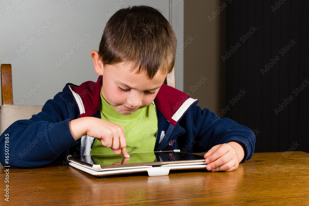 Little boy playing on tablet computer Little boy playing on tablet computer