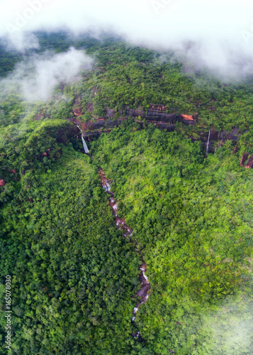 Beautiful waterfall in autumn forest from Drone photo