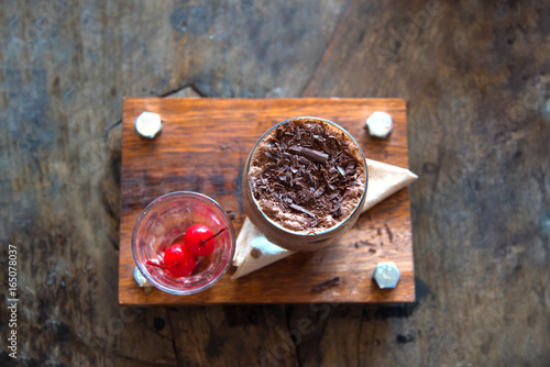 Ice chocolatto, intense chocolate mocha strinkle topping  serve with red cherry yummy beverage.