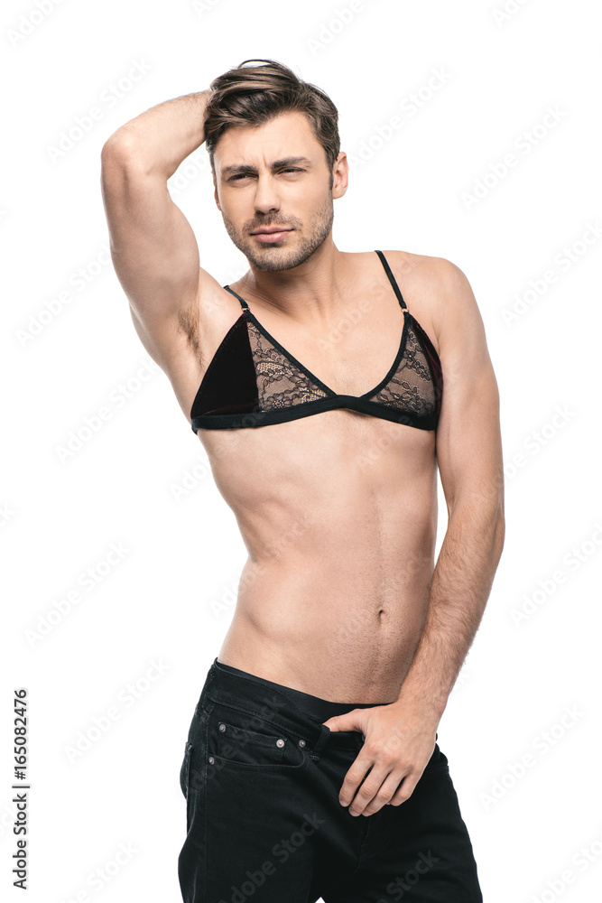 young handsome homosexual man posing in womens bra, isolated on white Stock  Photo