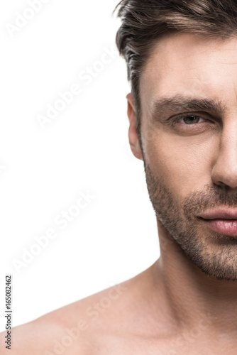 portrait of young handsome man looking at camera, isolated on white