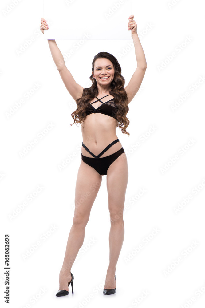 smiling beautiful young woman in black lingerie with blank banner, isolated on white smiling beautiful young woman in black lingerie with blank banner, isolated on white