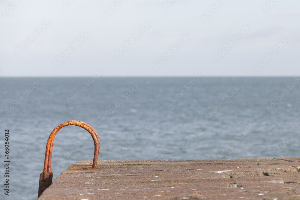 Fototapeta premium Rusty old ladder to the sea