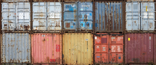 Stack of colourful and rusty containers in the port of Antwerp