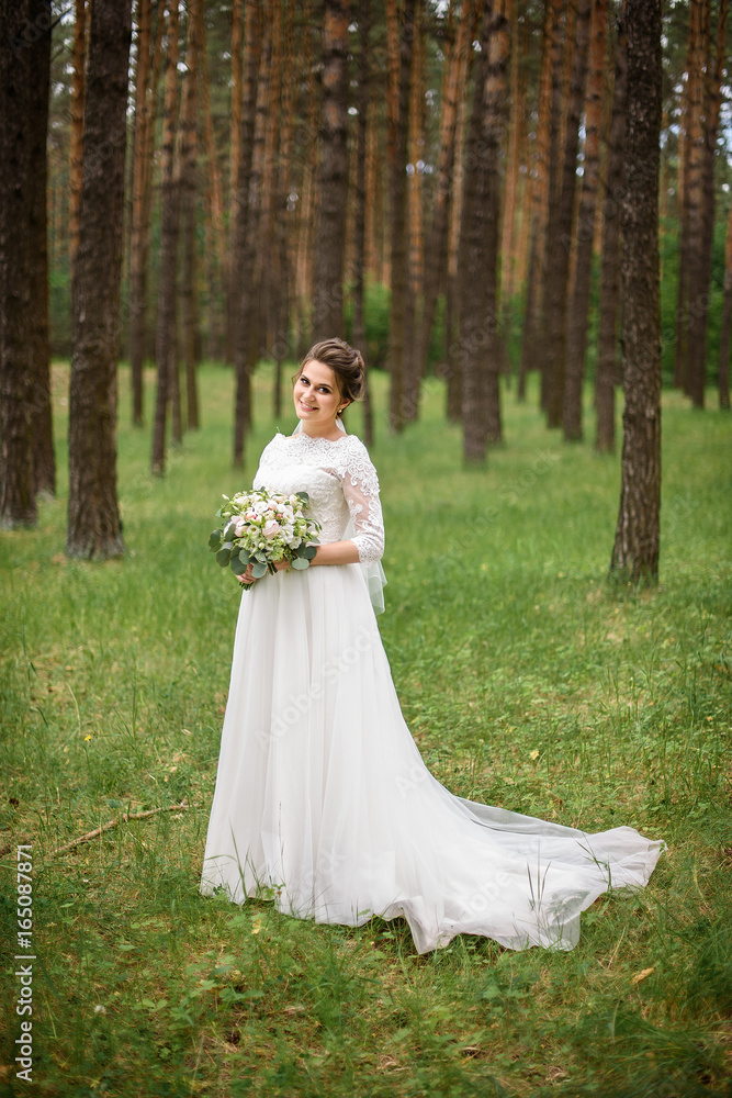 Beautiful bride in white wedding dress with bridal bouquet